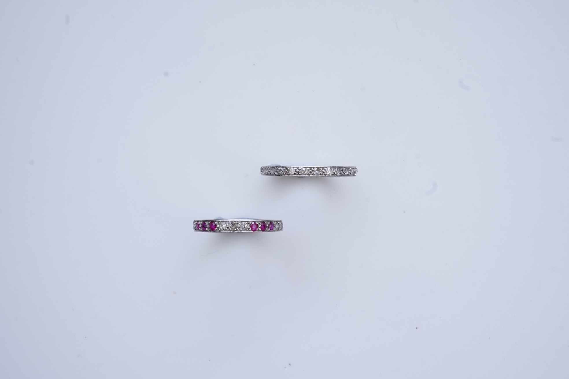 A diamond eternity ring and a ruby and diamond half eternity ring, mid 20th century